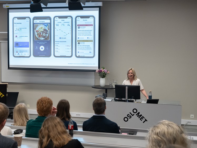 Lerret på vegg med bilder av mobilskjermer, person holder foredrag